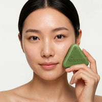 Woman holding Nidoriva scalp bar to cheek